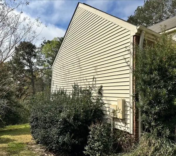 The same siding washed back to clean cream